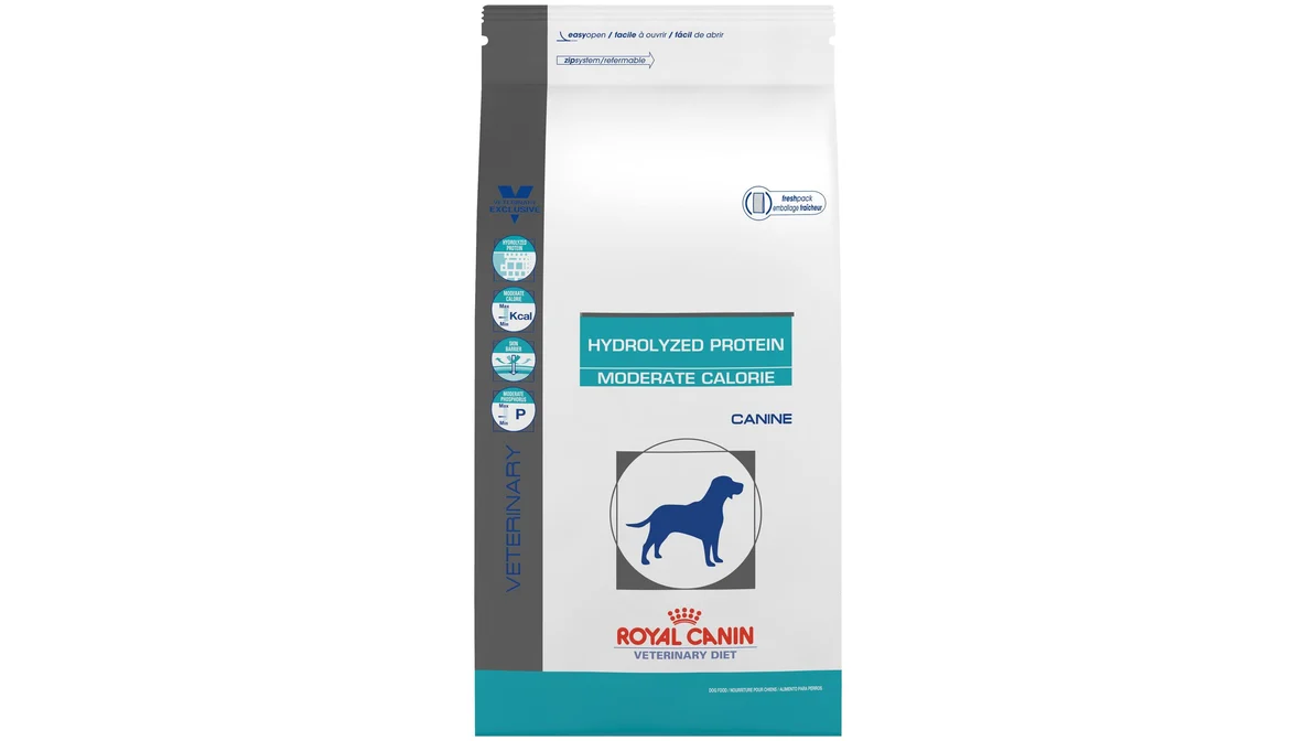 A bag of veterinary hydrolyzed protein dog food sitting on a kitchen floor next to a stainless steel dog bowl